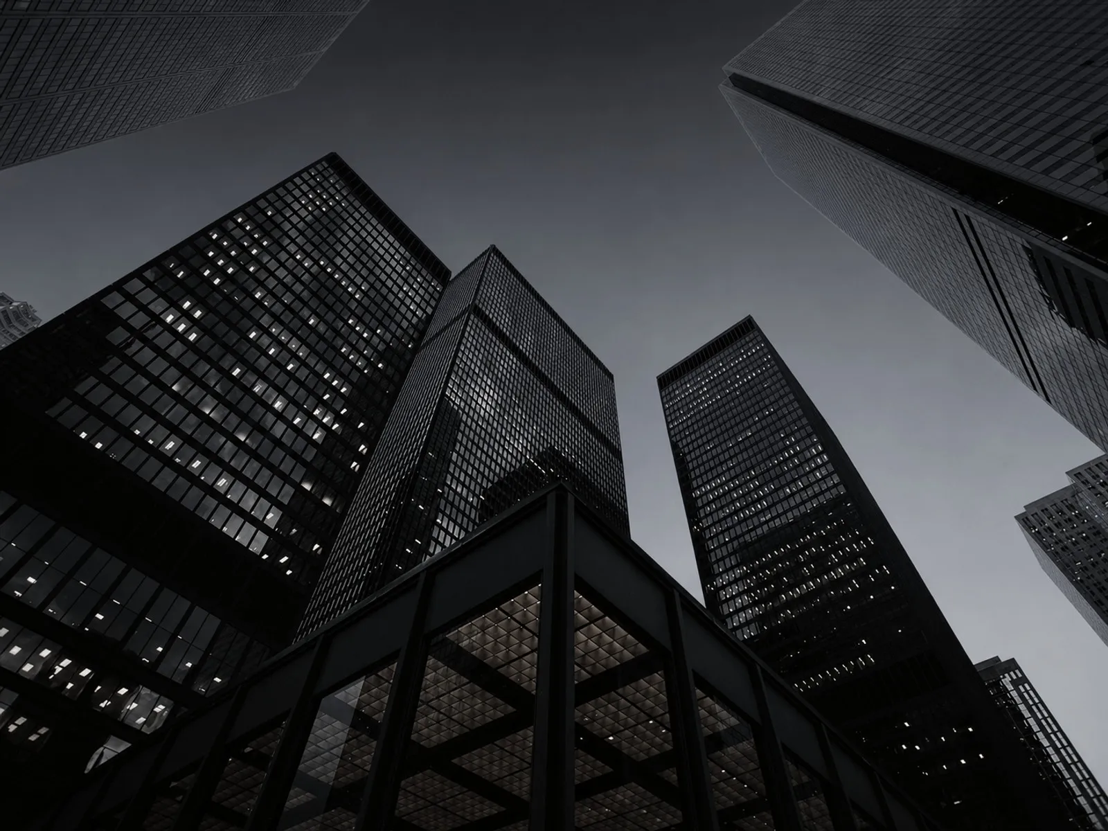 Looking up at dark glass office towers.
